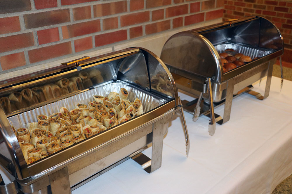 Two chafing dishes full of appetizers are pictured in the atrium of the Beckman Institute at the University of Illinois at Urbana-Champaign (UIUC)