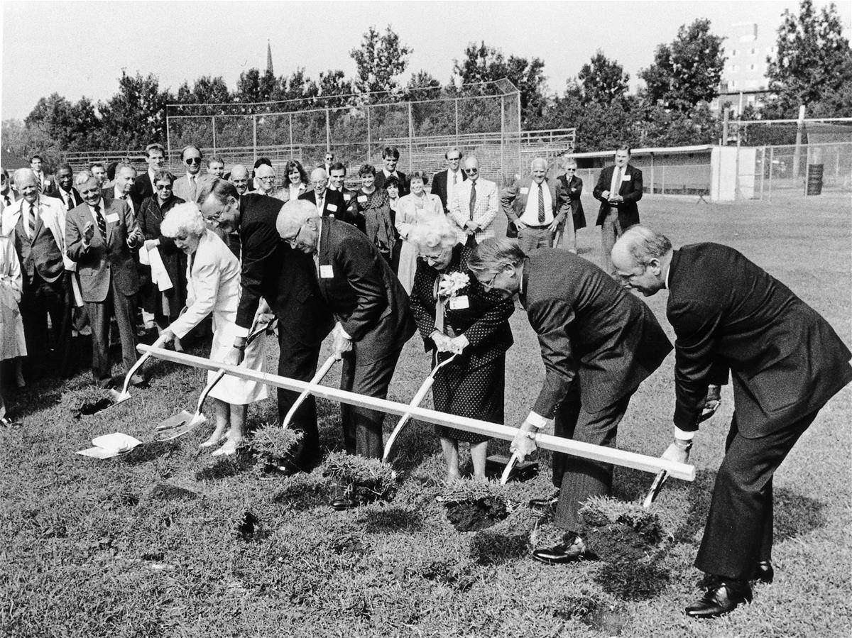 A group of people hold a connected shovel as they break ground on the Beckman Institute at the University of Illinois at Urbana-Champaign (UIUC)